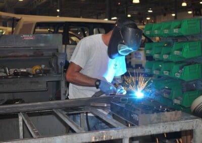 worker welding metal with sparks